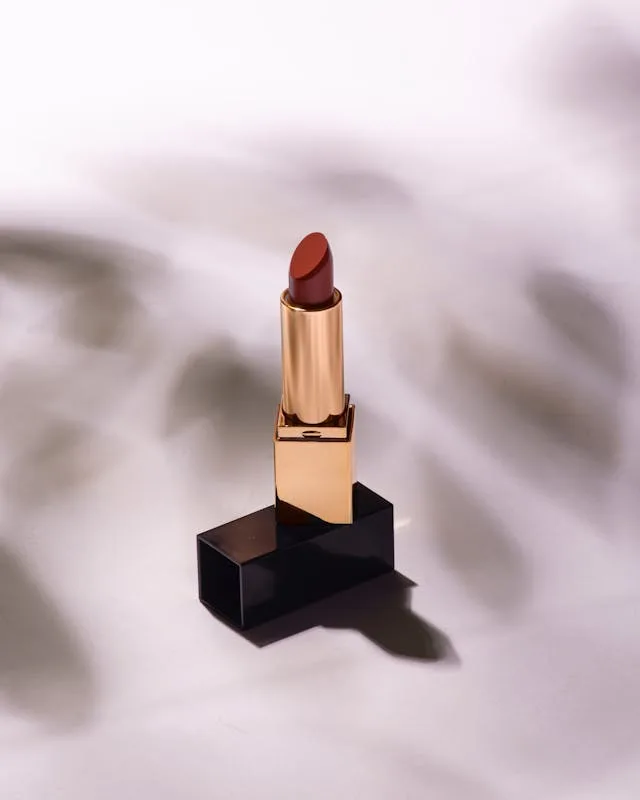 MAC Red Retro Matte Lipstick in a gold and black tube, a classic festive red lipstick for a winter glow look.